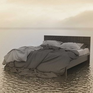 in Bett steht mit aufgewühlten Laken inmitten des Meers